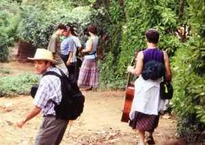 jon-wingates-entering-woods-to-play-music-for-community-gathering-el-salvador