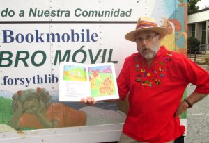 jon-sharing-bossy-gallito-behind-librarys-hispanic-bookmobile-purchased-by-jon-with-mural-he-designed-with-cuiban-painter-raul-montero