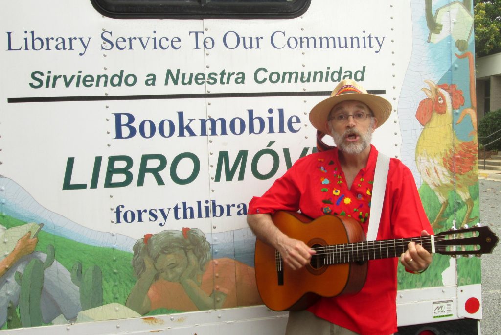Singing in front of Forsyth Public  Library Hispanic bookmobile (purchased by Jon and co-designed with Cuban artist, Raul Montero)